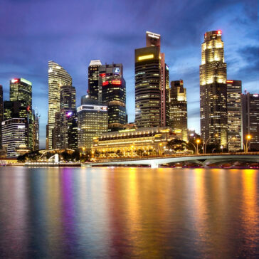 Singapore city skyline at dusk, a popular destination for business class flights from San Francisco.