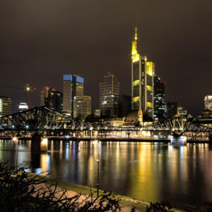 Frankfurt skyline and river at night — a top European destination for travelers booking business class flights to Frankfurt.