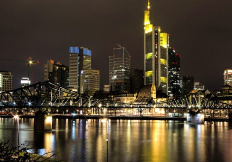 Frankfurt skyline and river at night — a top European destination for travelers booking business class flights to Frankfurt.