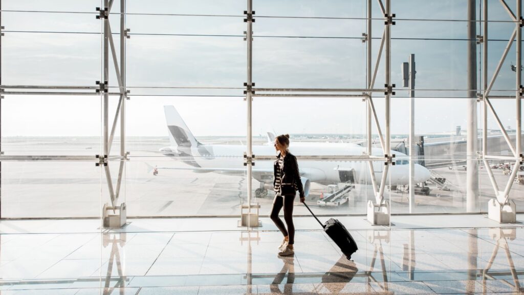 Business traveler walking through airport terminal – affordable and discounted business class flight deals